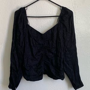 Black off shoulder shirt.